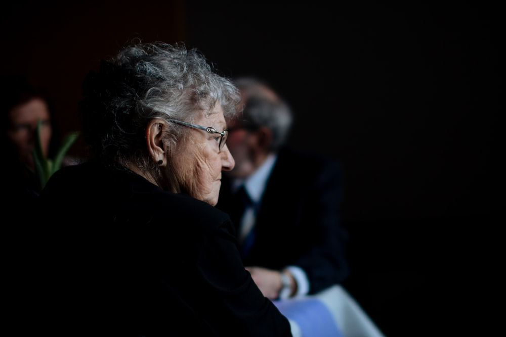 An elderly woman sitting